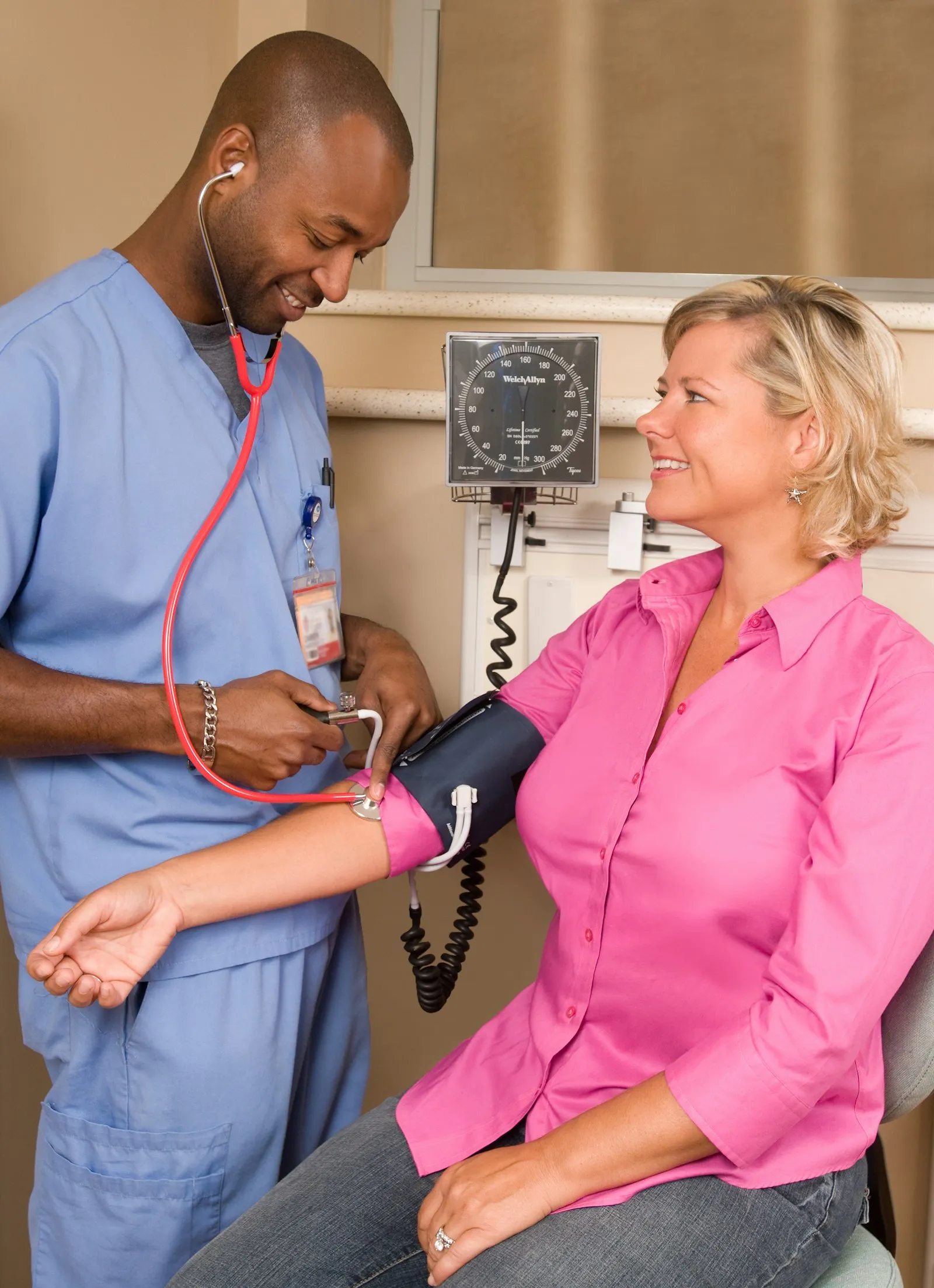 Clinician checking a woman’s blood pressure