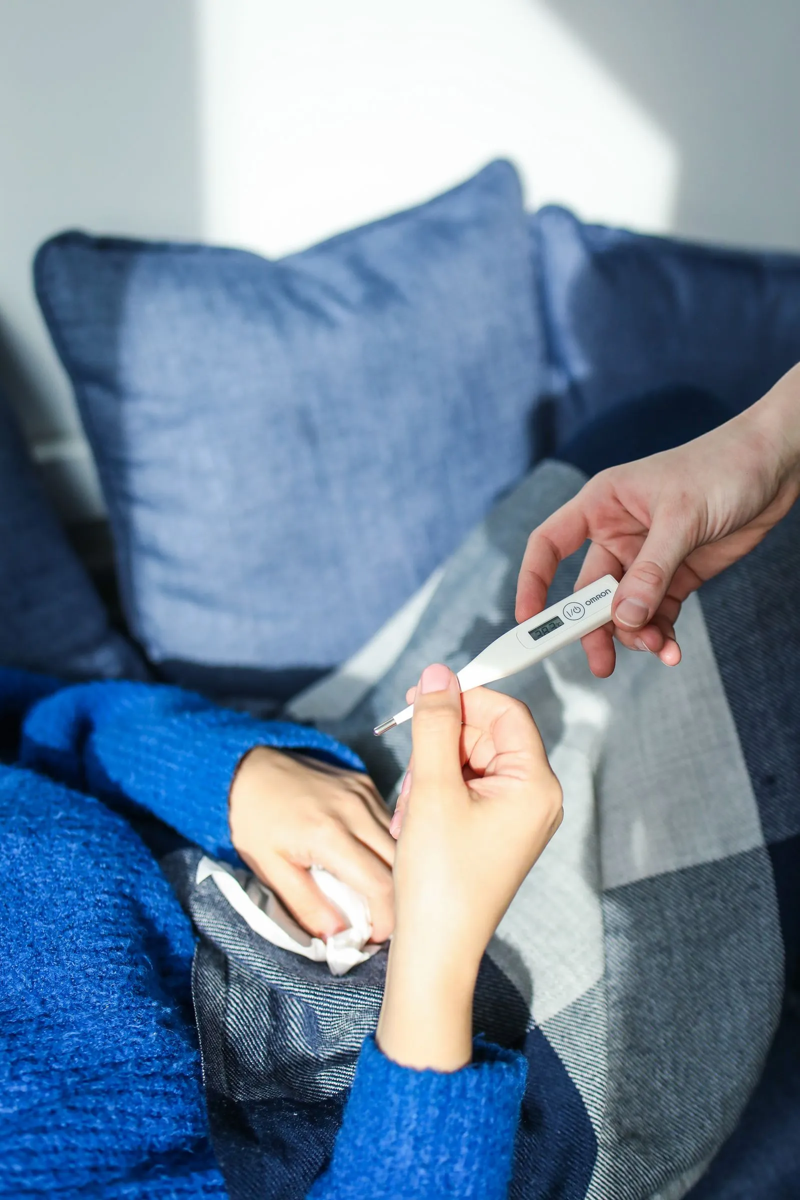 Hand holding a digital thermometer