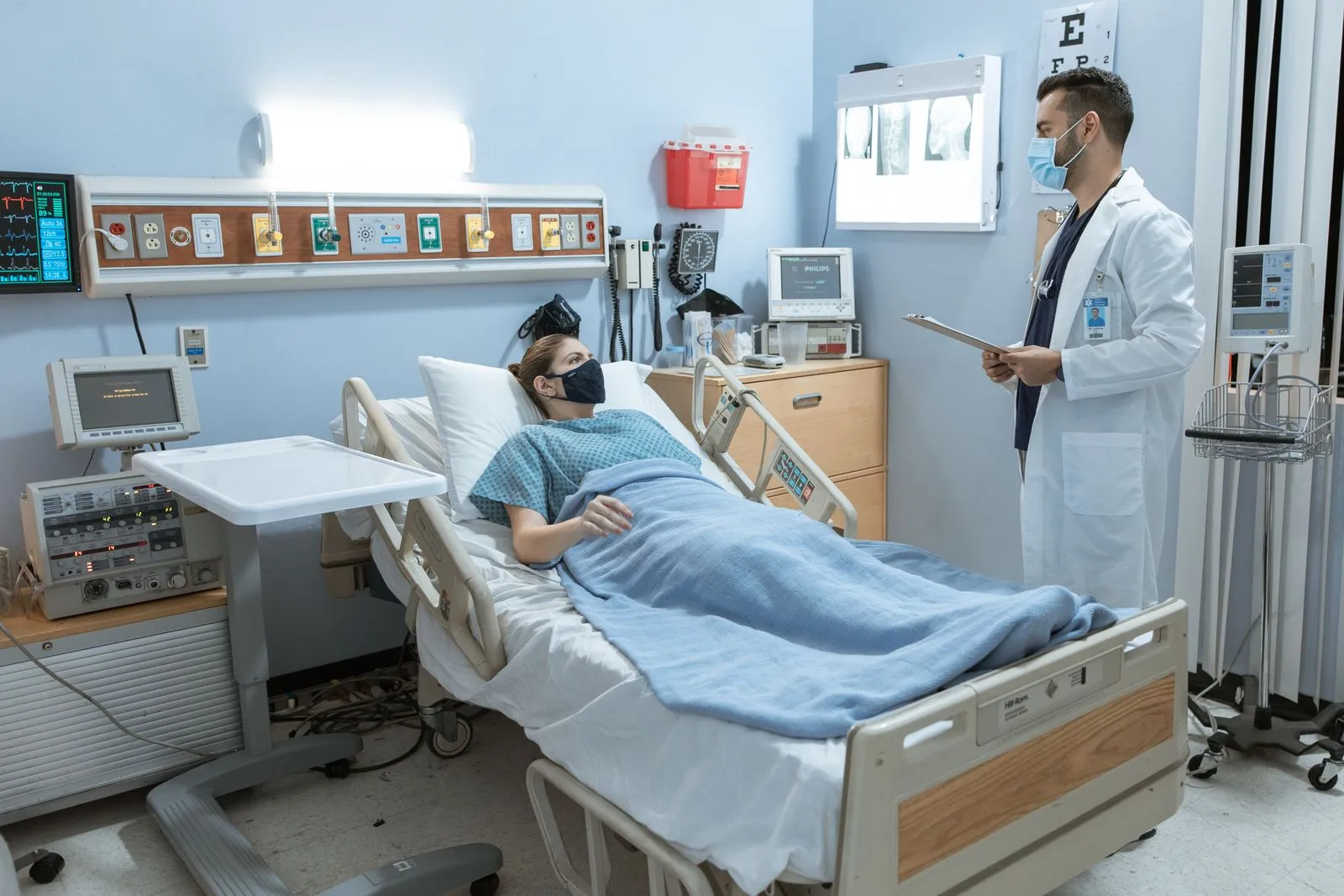 Doctor reviewing a chart with a patient in an exam room