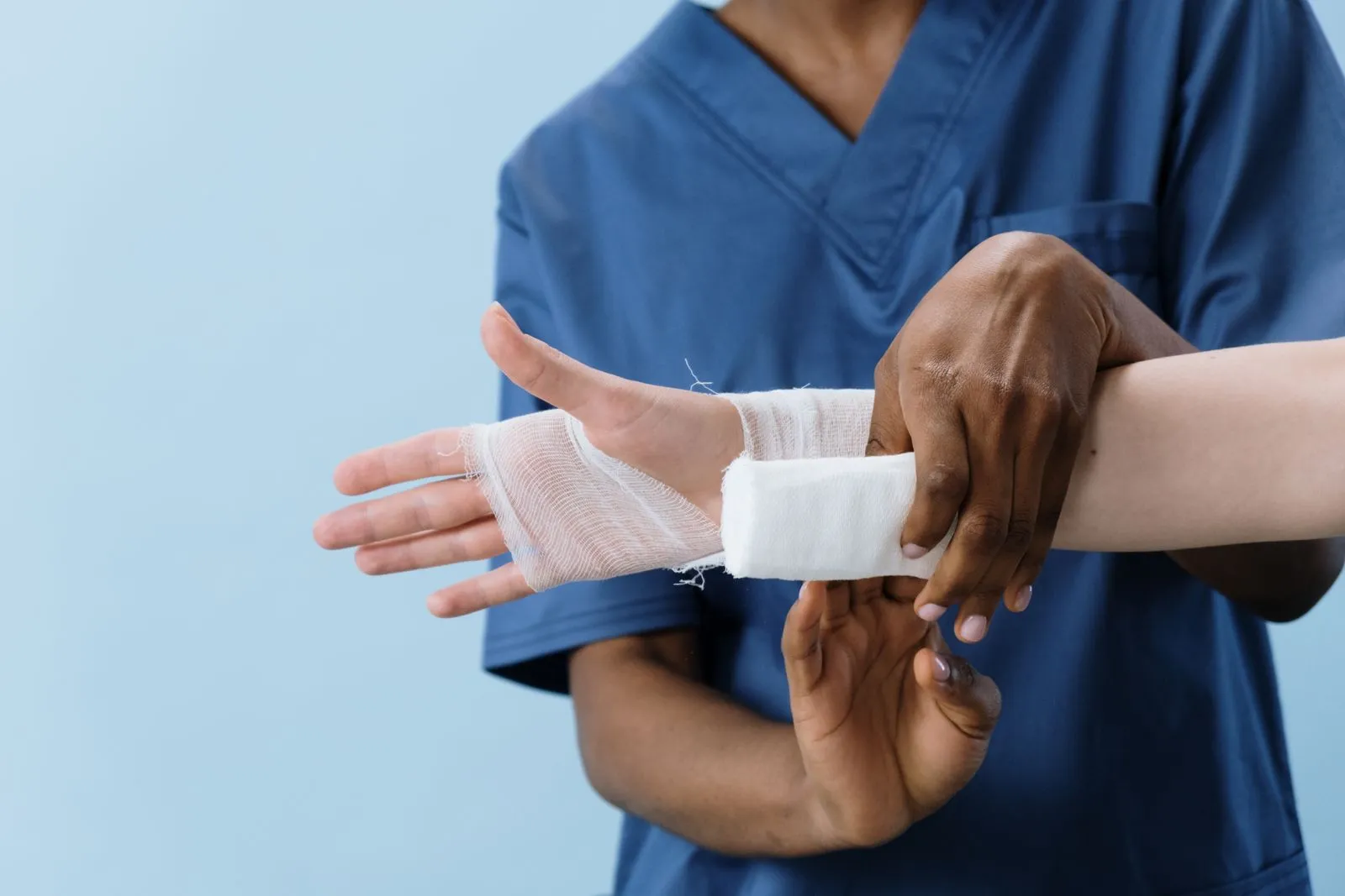 Nurse wrapping a bandage around a patient’s arm