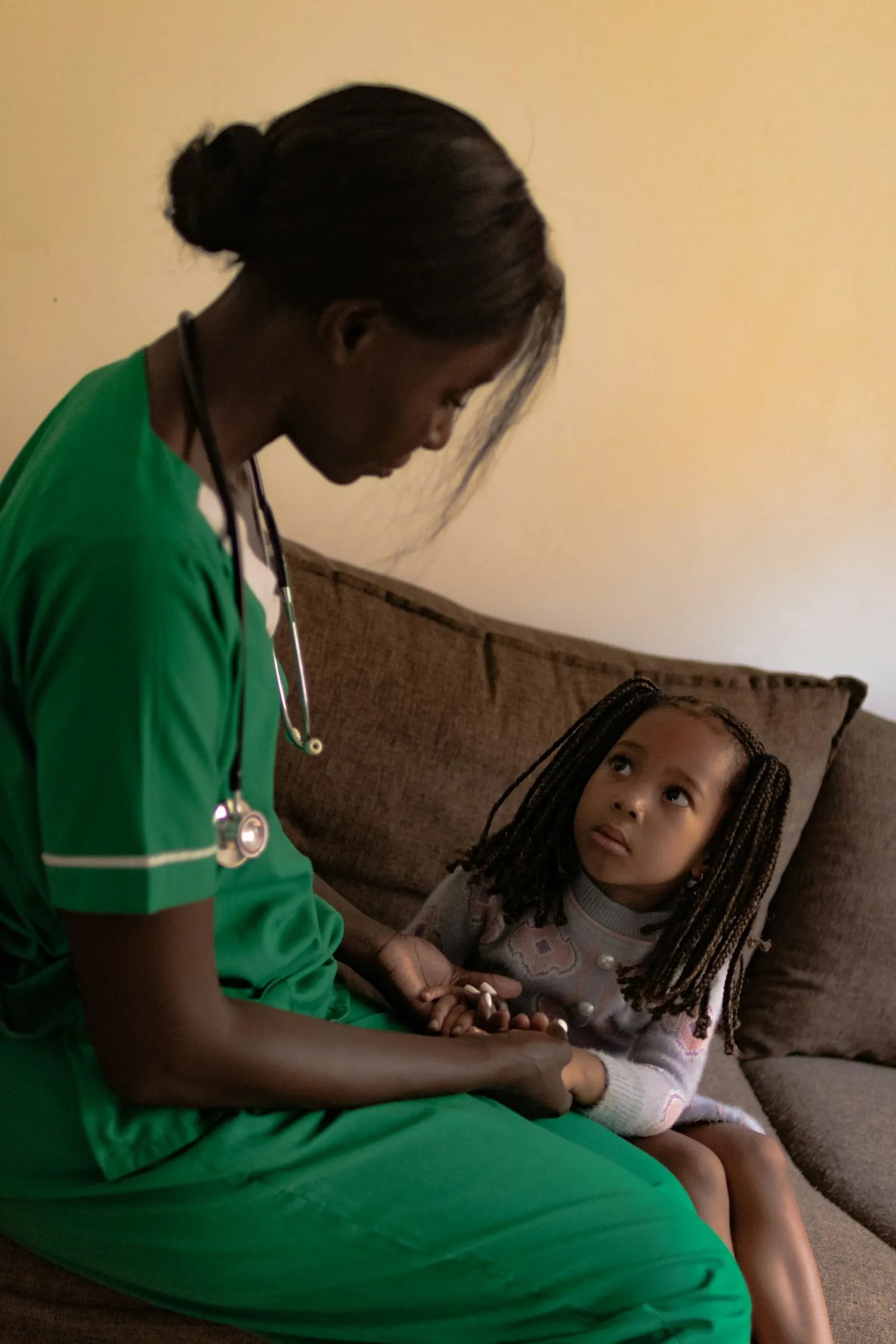 Nurse comforting a young child before treatment