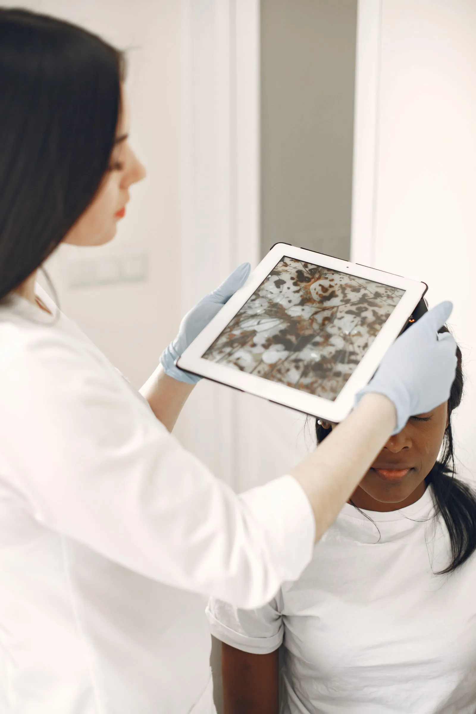 Clinician reviewing a skin condition photo on a tablet