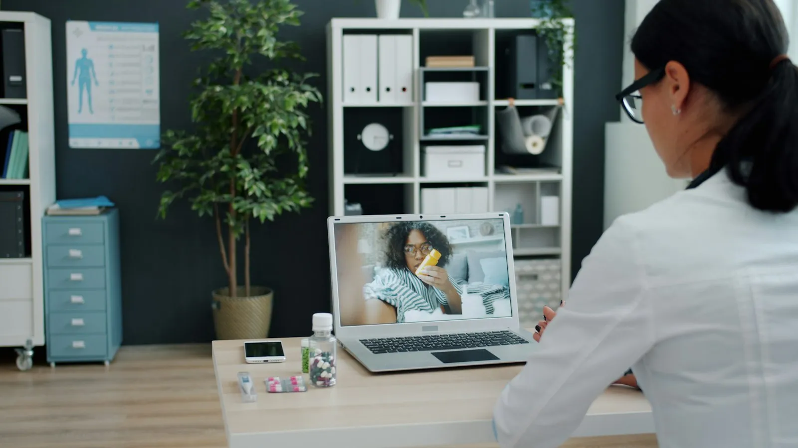 Patient on a telehealth video visit with a doctor on a laptop