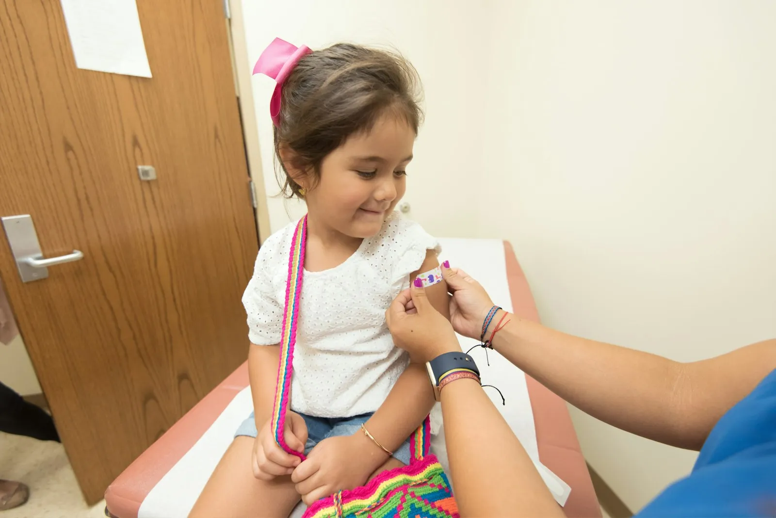 Girl receiving a vaccine from a nurse