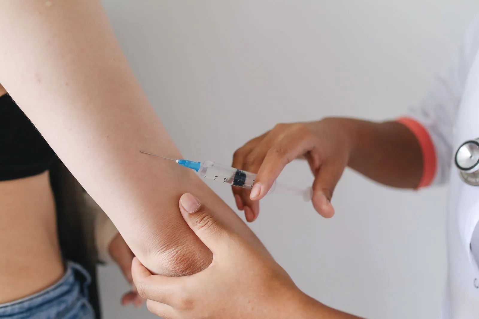 Clinician giving a vaccine shot in the arm