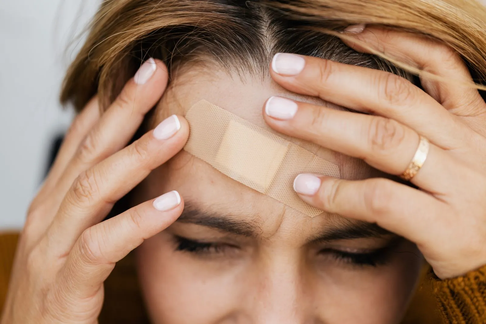 Woman with a bandage on her forehead after a cut